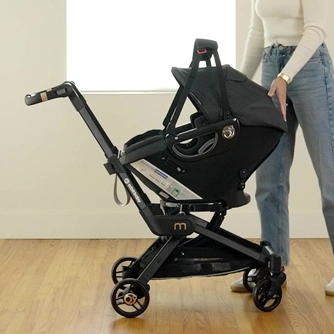 Orbit Baby Infant Car Seat docked on the M+ Stroller SmartHub